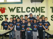 The U.S. Chess Trust helps young chessplayers. Pictured are, l to r, Frank Bubbico, Dylan Csencsits, Diego Vasquez, Serhiy Solovyov, Mason Chicotka, Michael Fitzmaurice, Casey Dath, Joshua Morales, Zachary Fitzmaurice (2014 rookie), Mr G, Kelby Dath, Ivan Caposito, Sam France, Victoria Spitzer, and Joseph Raetzer.